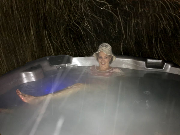 Karen Duquette in the hot tub on a snowy nigh